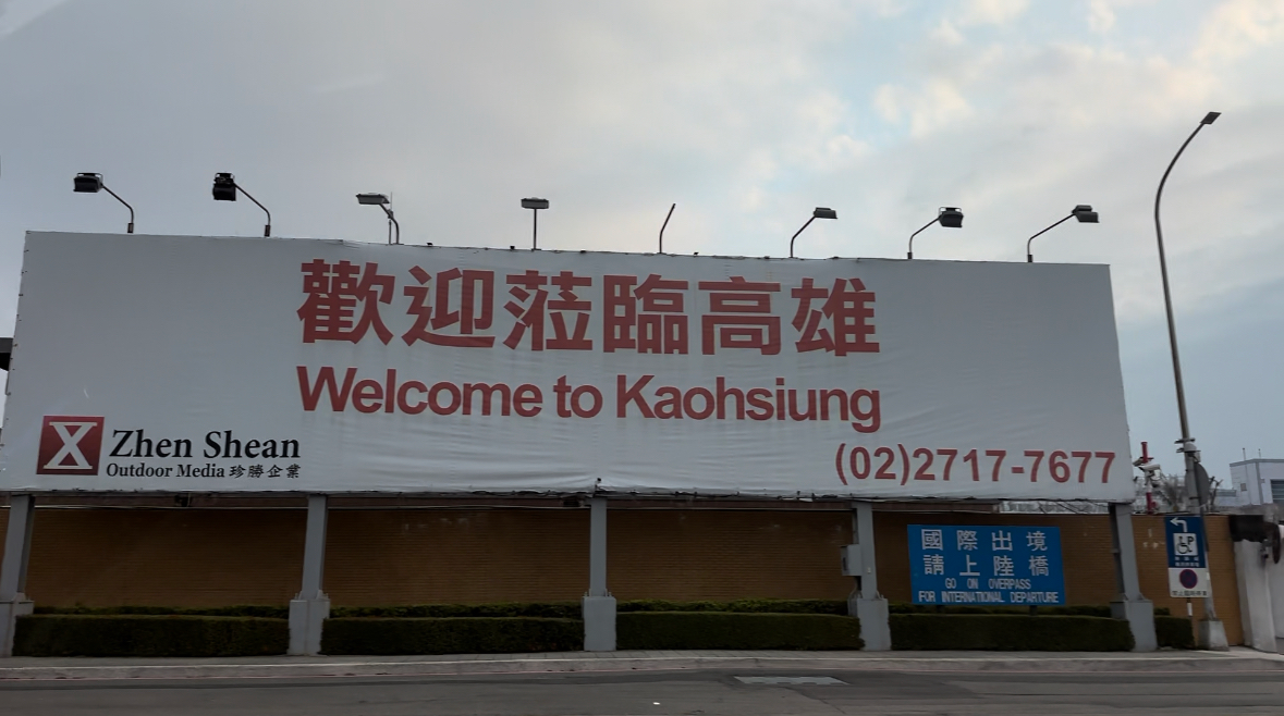 A billboard that says welcome to kaohsiung on it
