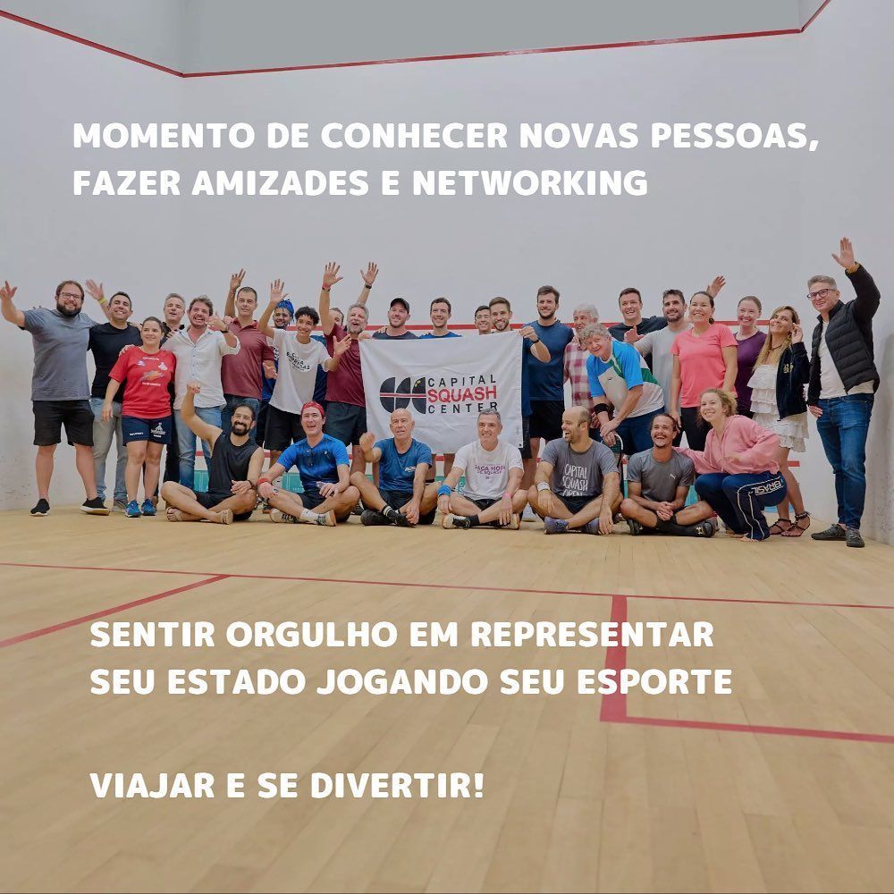 Um grupo de pessoas posando para uma foto em uma quadra de squash