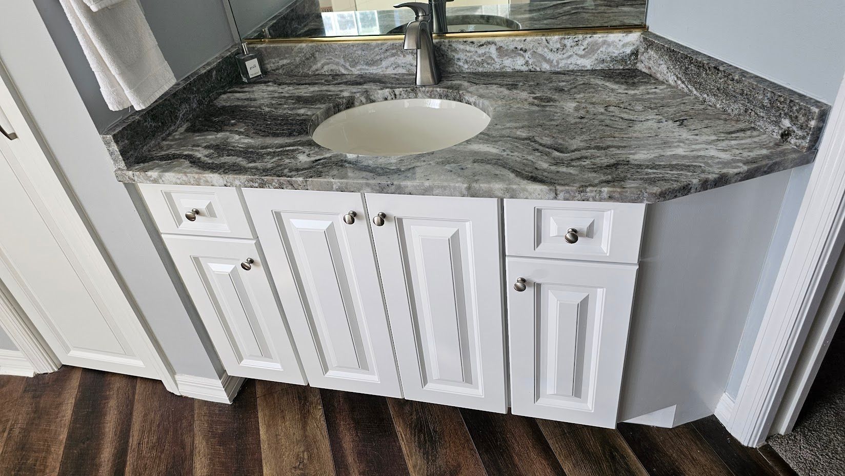 A bathroom vanity with a sink and a mirror.