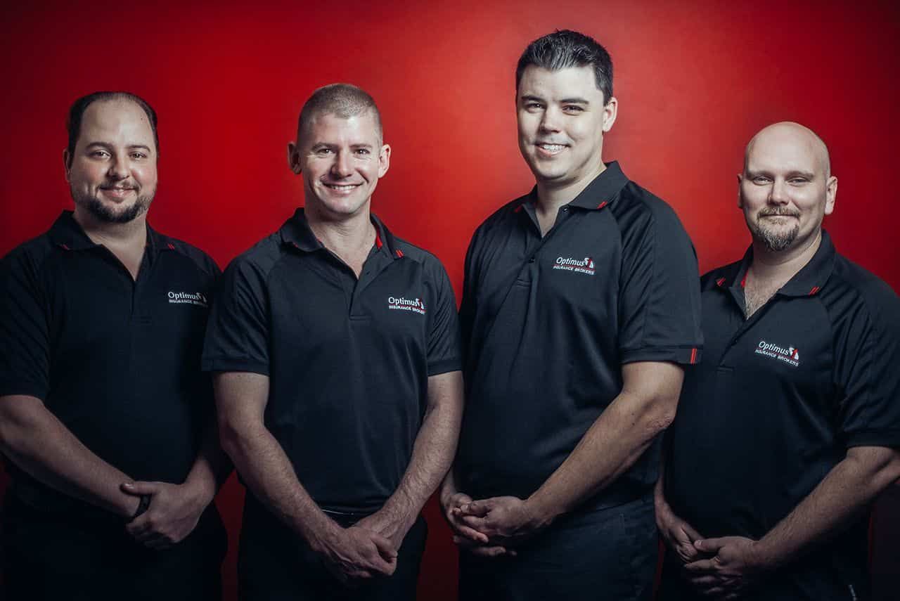 Five Staff Members Posing For A Photo — Optimus 1 Insurance Brokers in Westcourt, QLD