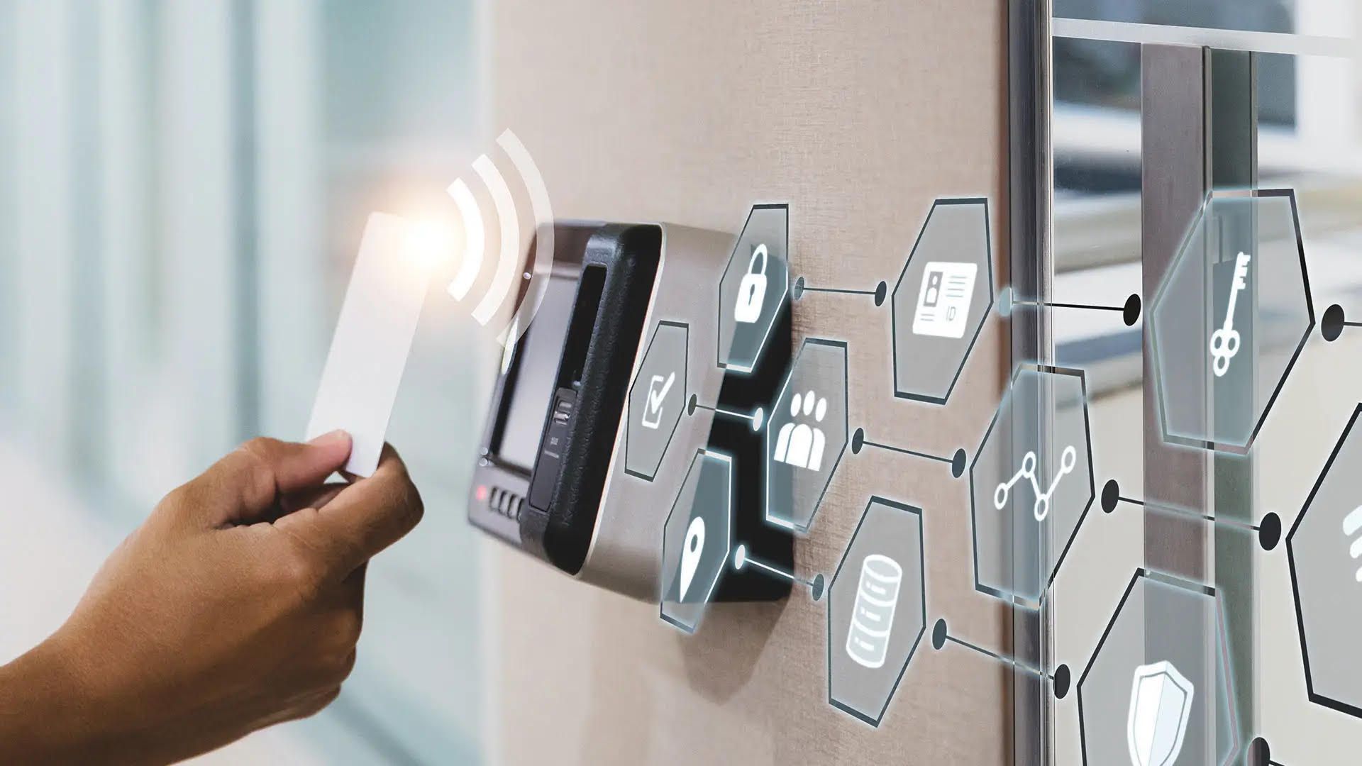 Hand scanning a card at a security access system. Access icons and glowing waves indicate data transfer.