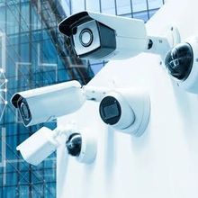 A group of security cameras are mounted on a wall.