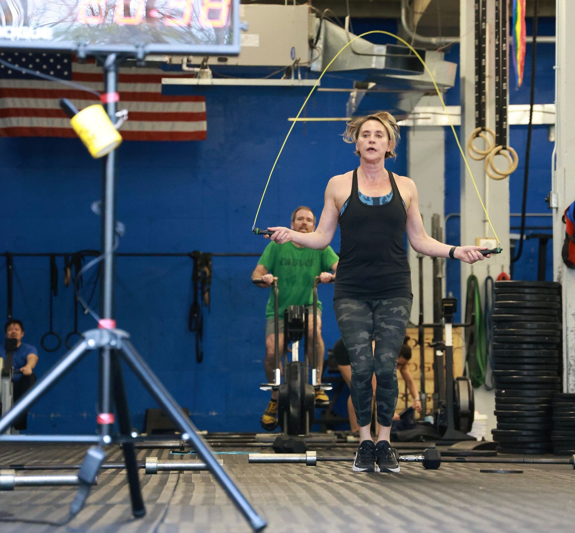 A woman is jumping a jump rope in a gym