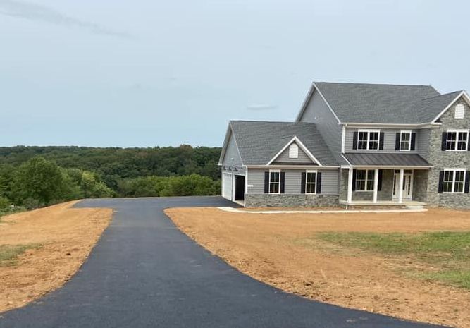 A large house with a driveway leading to it.
