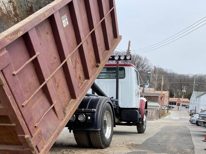 A dump truck with a red dumpster on the back of it