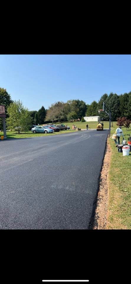 A asphalt road is being paved in a parking lot.