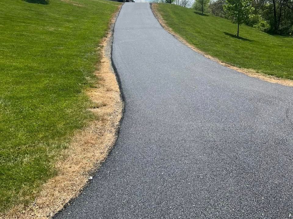 Freshly paved residential asphalt driveway installed by CM Ayres.