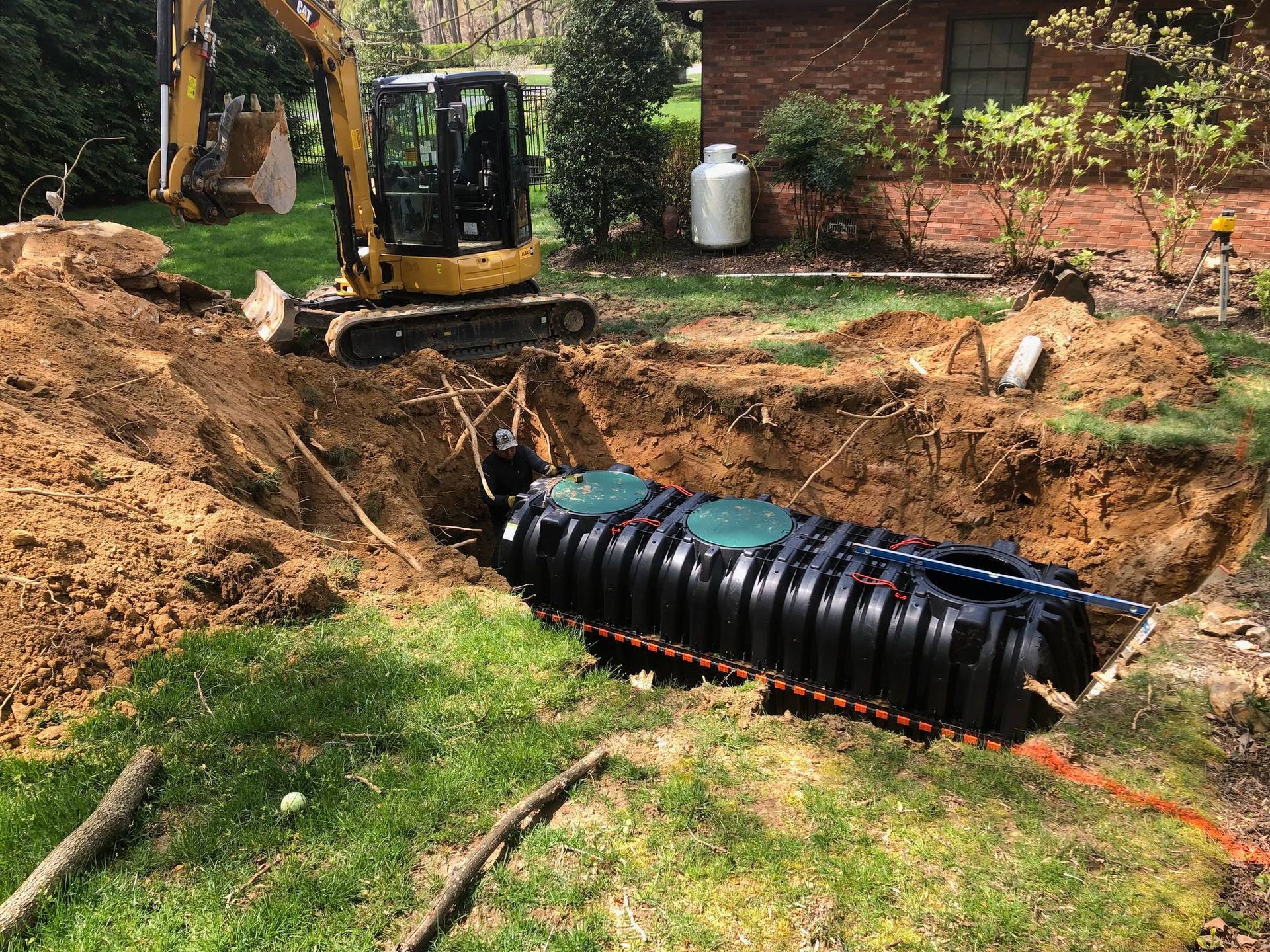 A large septic tank is being installed in a backyard.