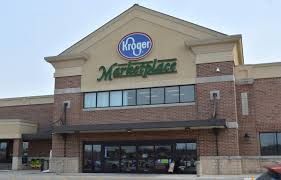 Kroger Marketplace storefront with brick facade and green signage under a clear sky