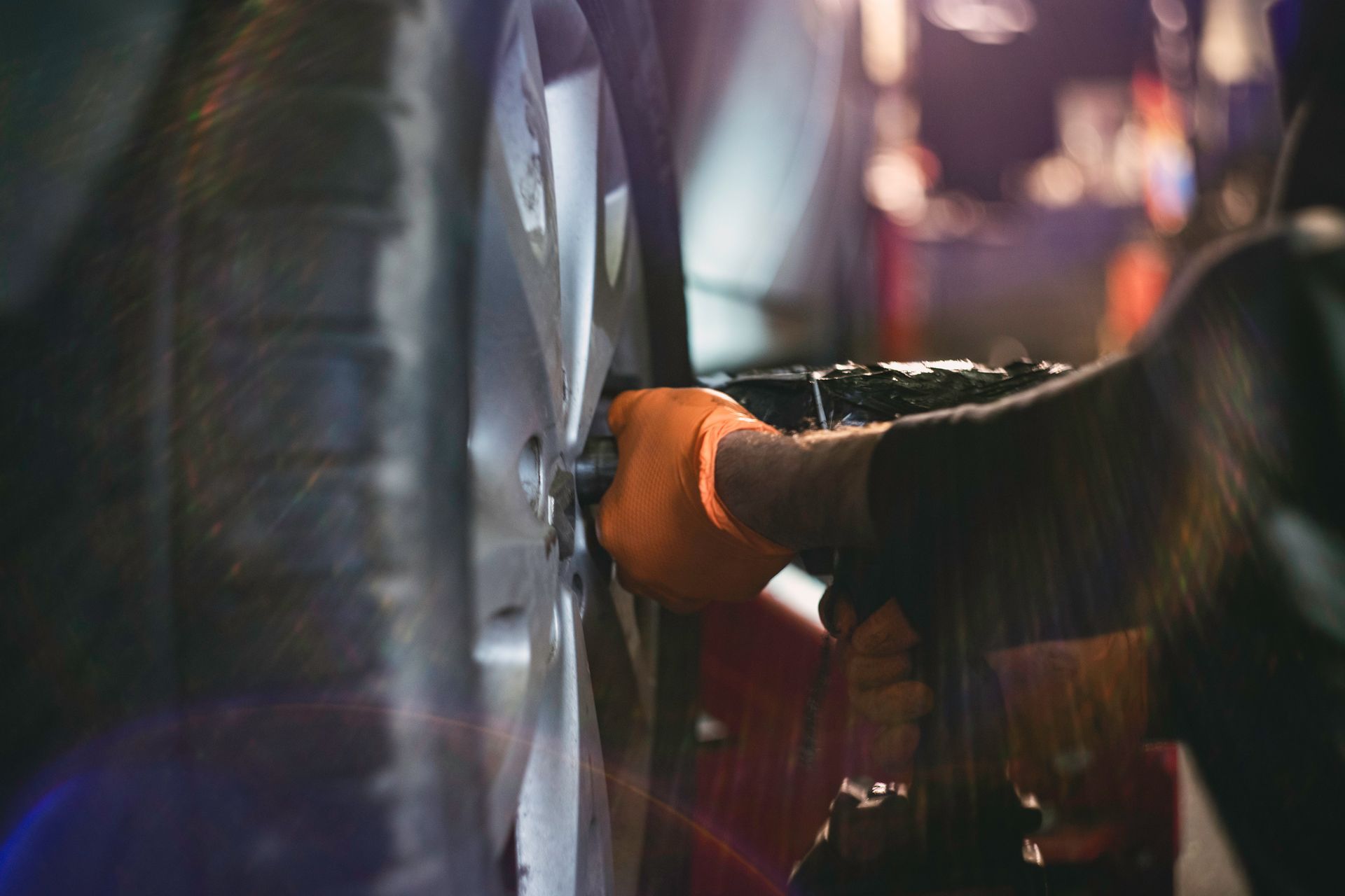 A close up of a person changing a tire on a car. A close up of a person changing a tire on a car.