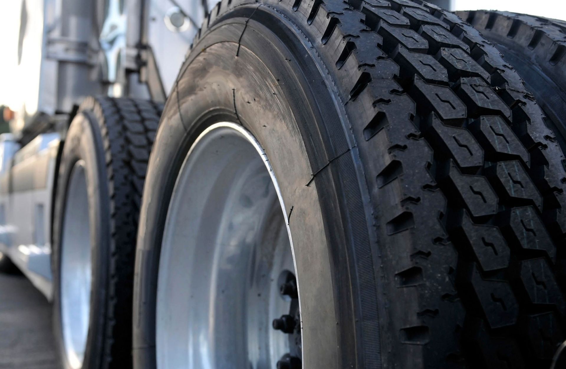 A close up of a truck 's tires and wheels A close up of a truck 's tires and wheels