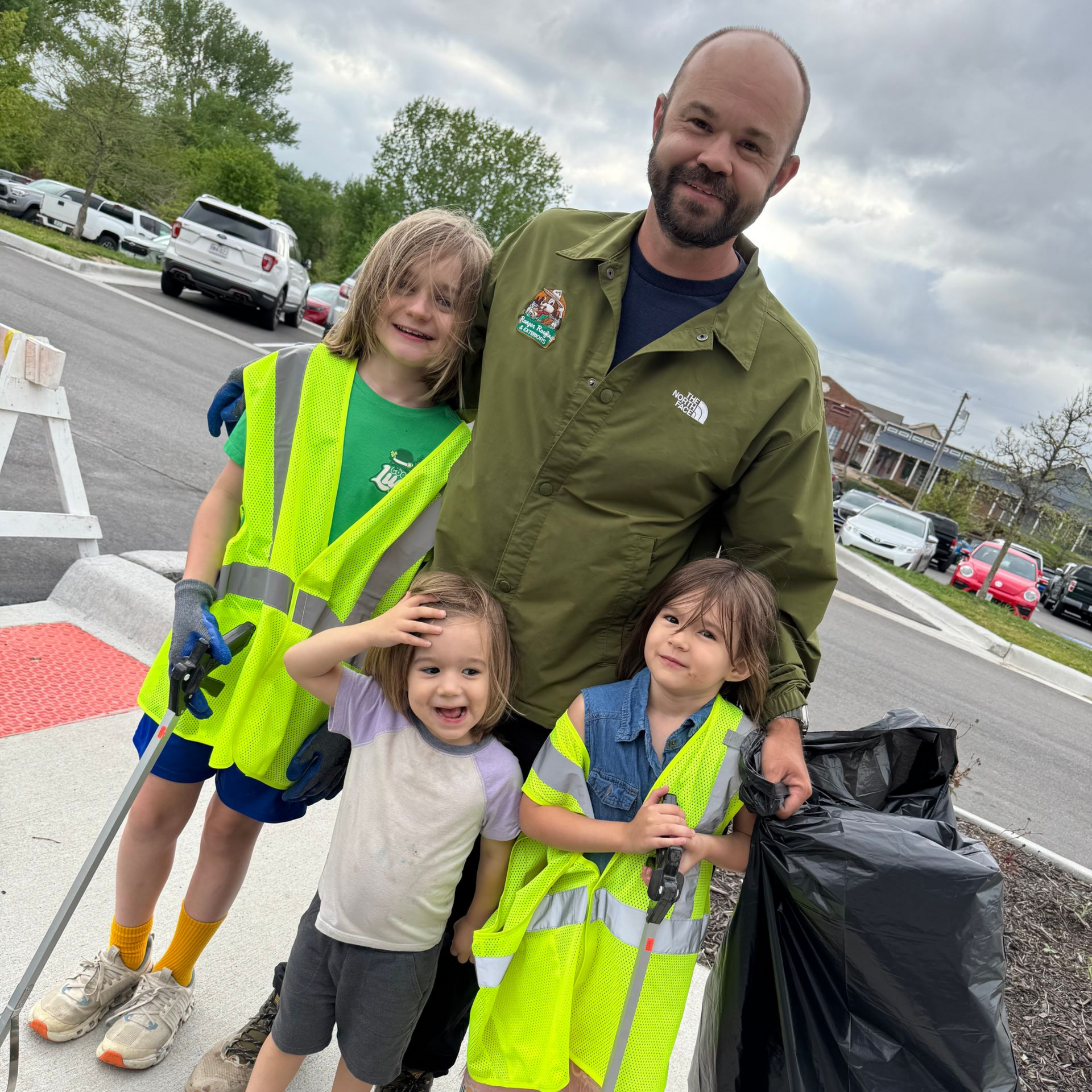 Owner Chris Music and 3 of his children in Downtown Parkville during Earth Day
