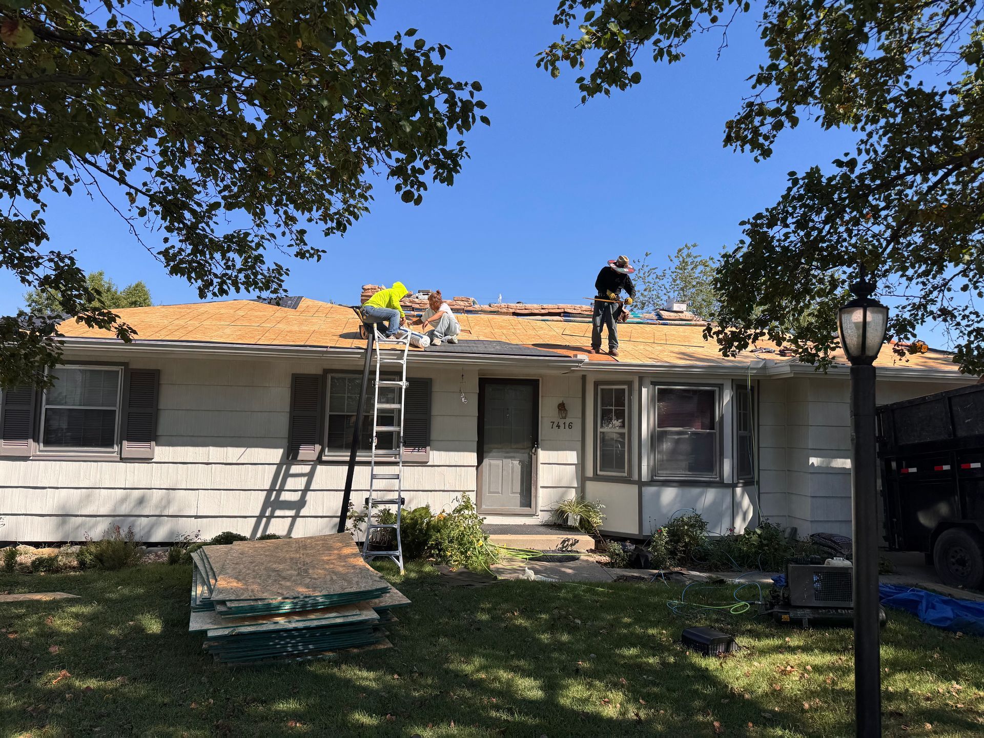Three Roofers Are Replacing The Decking Of A Roof