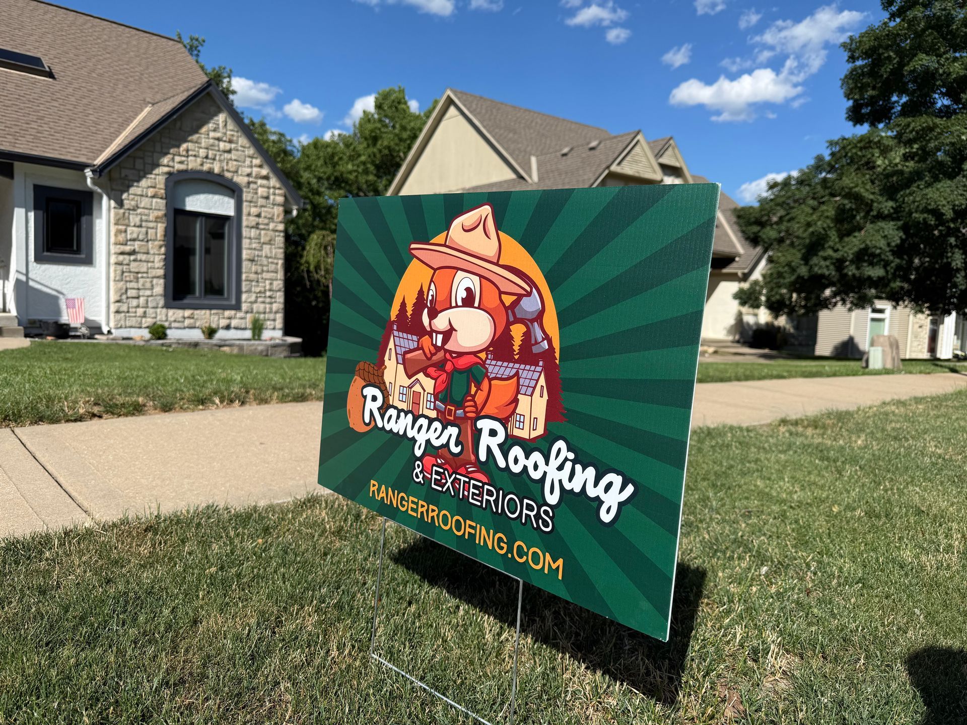 Ranger Rooging Yard sign in the front yard. A home with a recently replaced roof shows behind it.