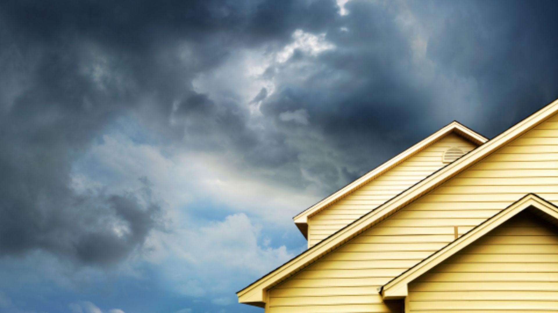 A house with a cloudy sky in the background