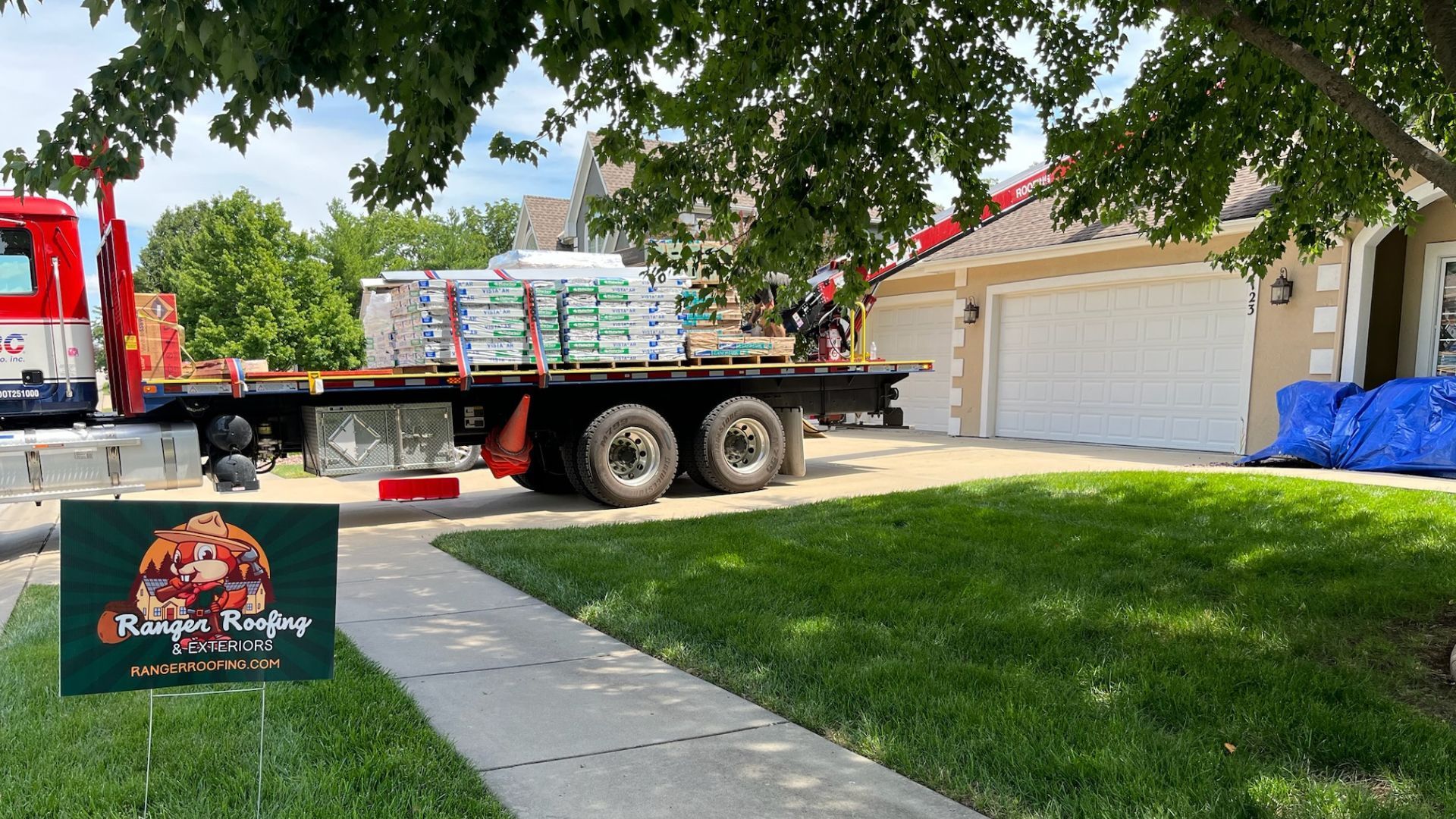 A large truck is parked in front of a house.