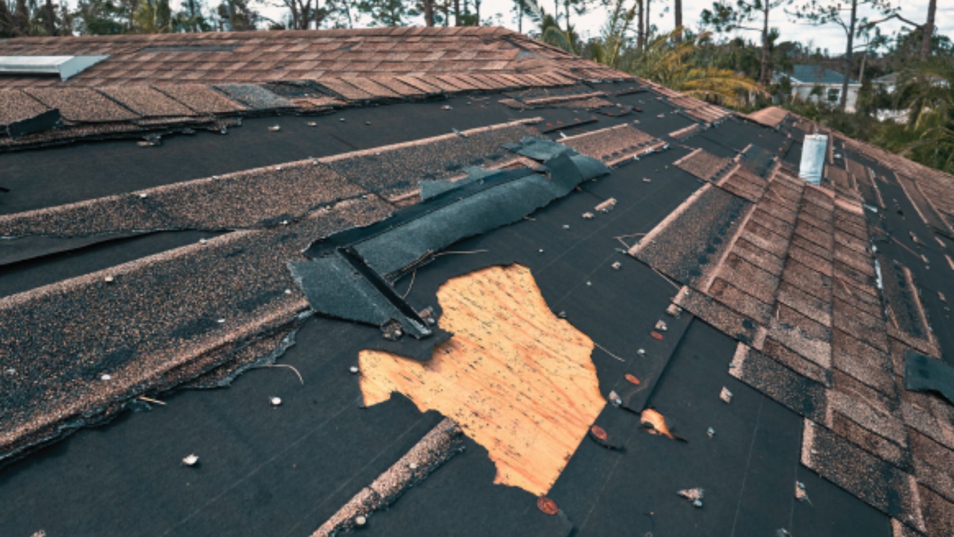 A roof with a hole in it and a piece of wood on it.
