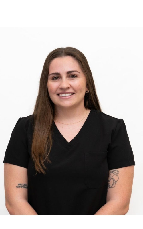 Smiling person in a black shirt against a white background.