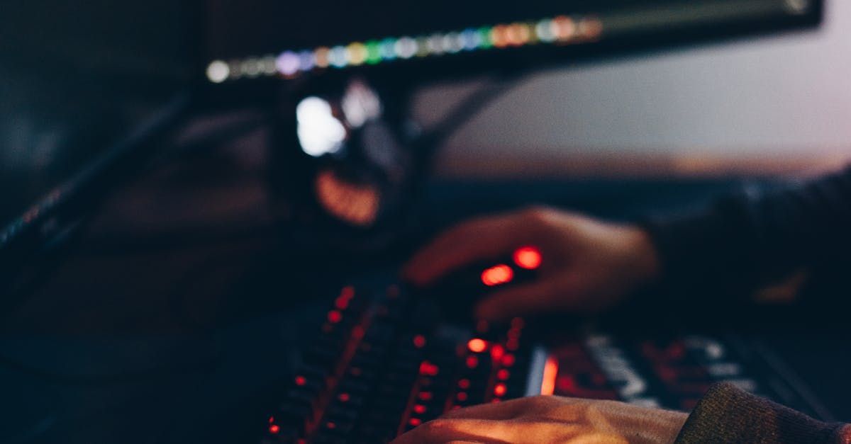 A person is using a computer mouse and keyboard in front of a computer monitor.