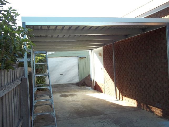 A carport with a ladder in front of it