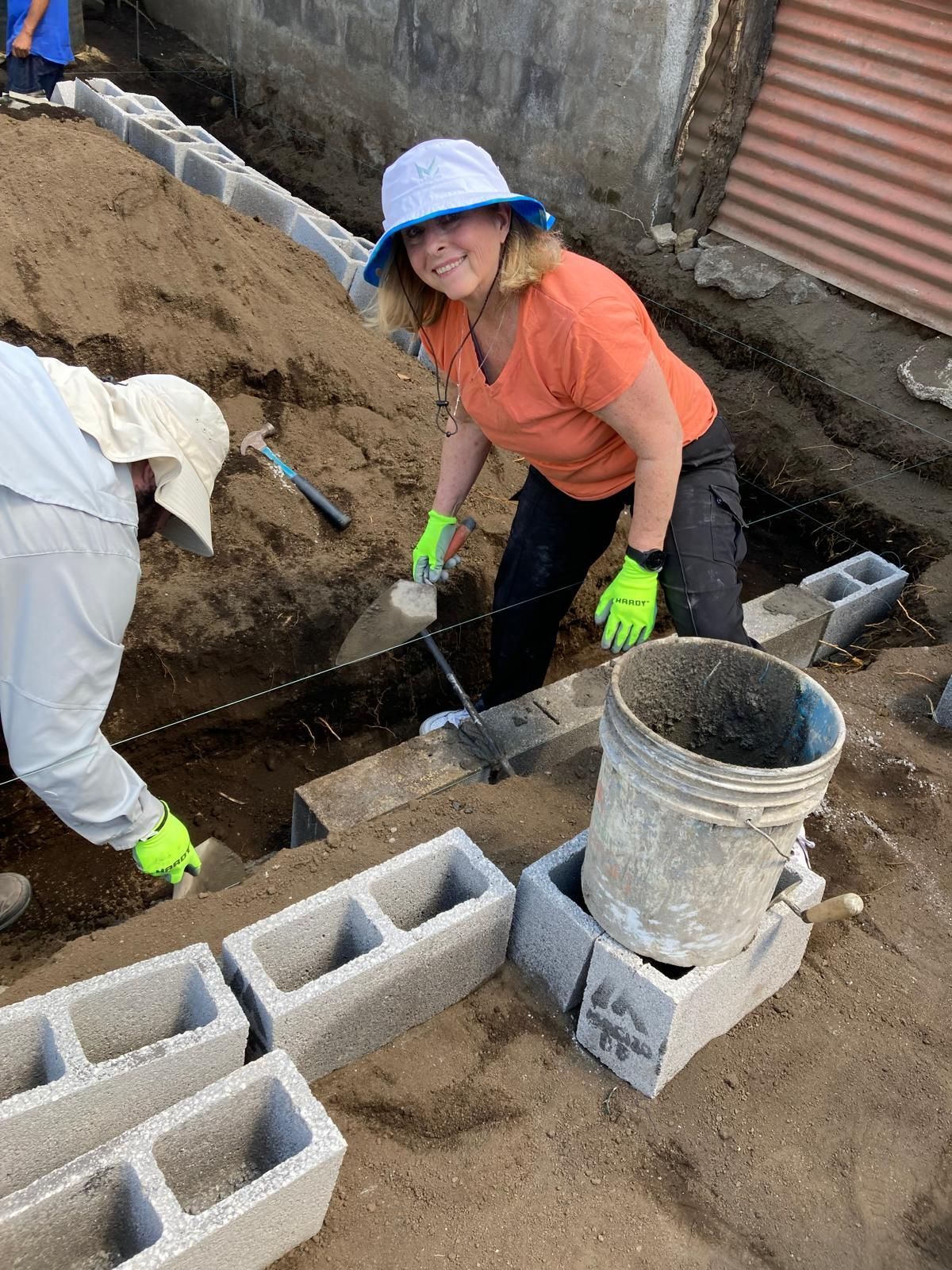 A man and a woman are working on a construction site.