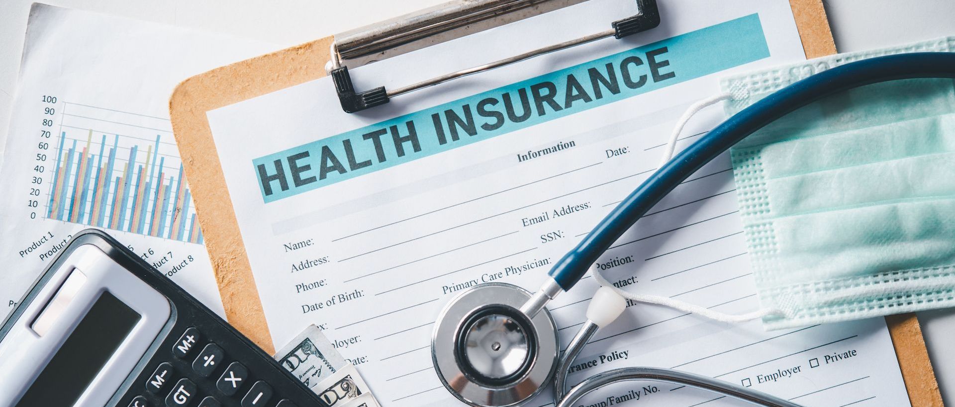 A stethoscope is sitting on top of a health insurance form.