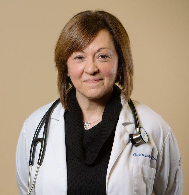 A woman in a white lab coat with a stethoscope around her neck