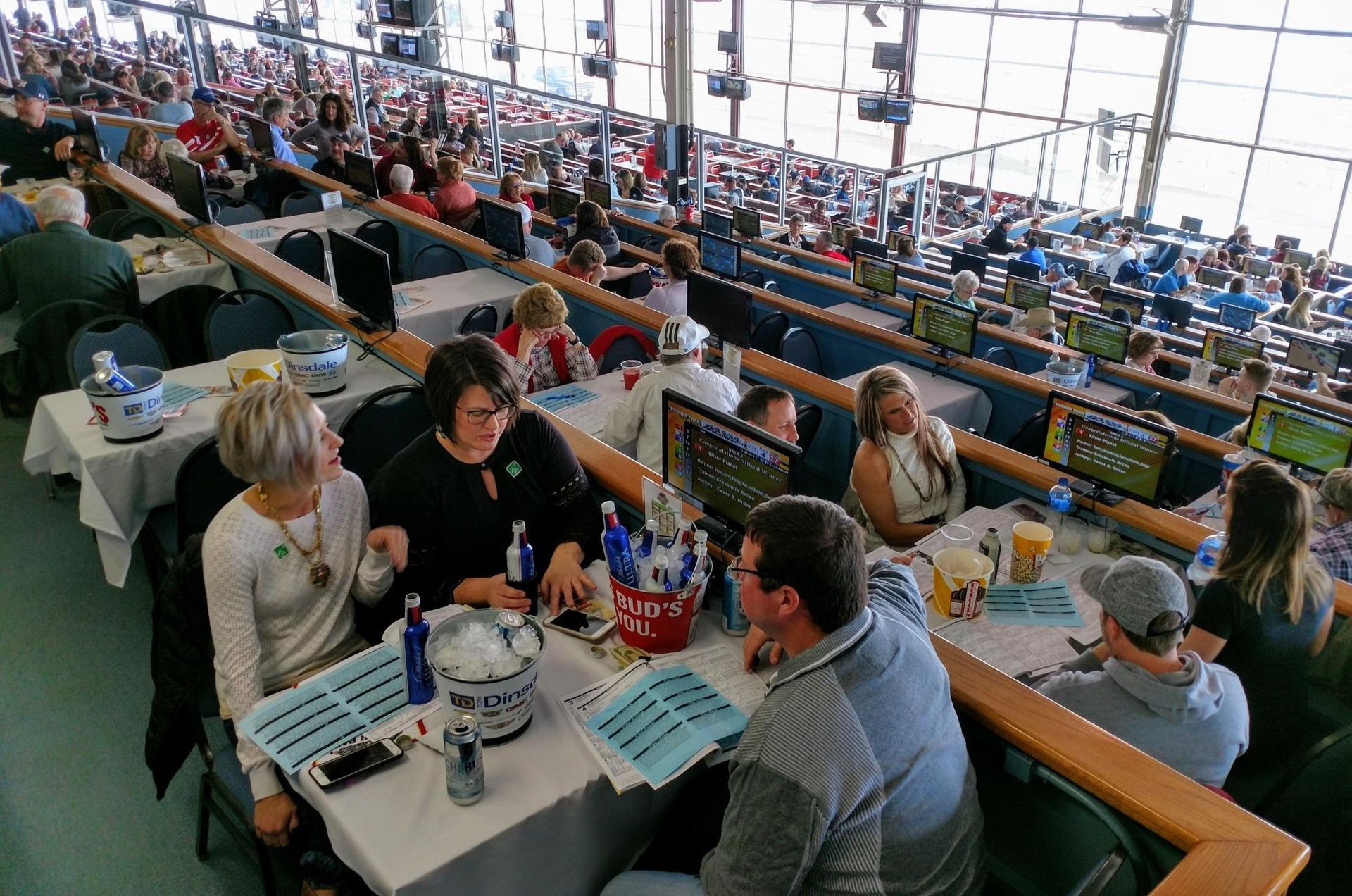 A group of people are sitting at tables in a stadium.