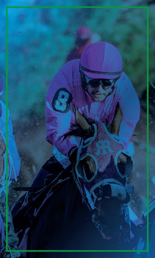 A jockey in a pink helmet is riding a horse in a race.