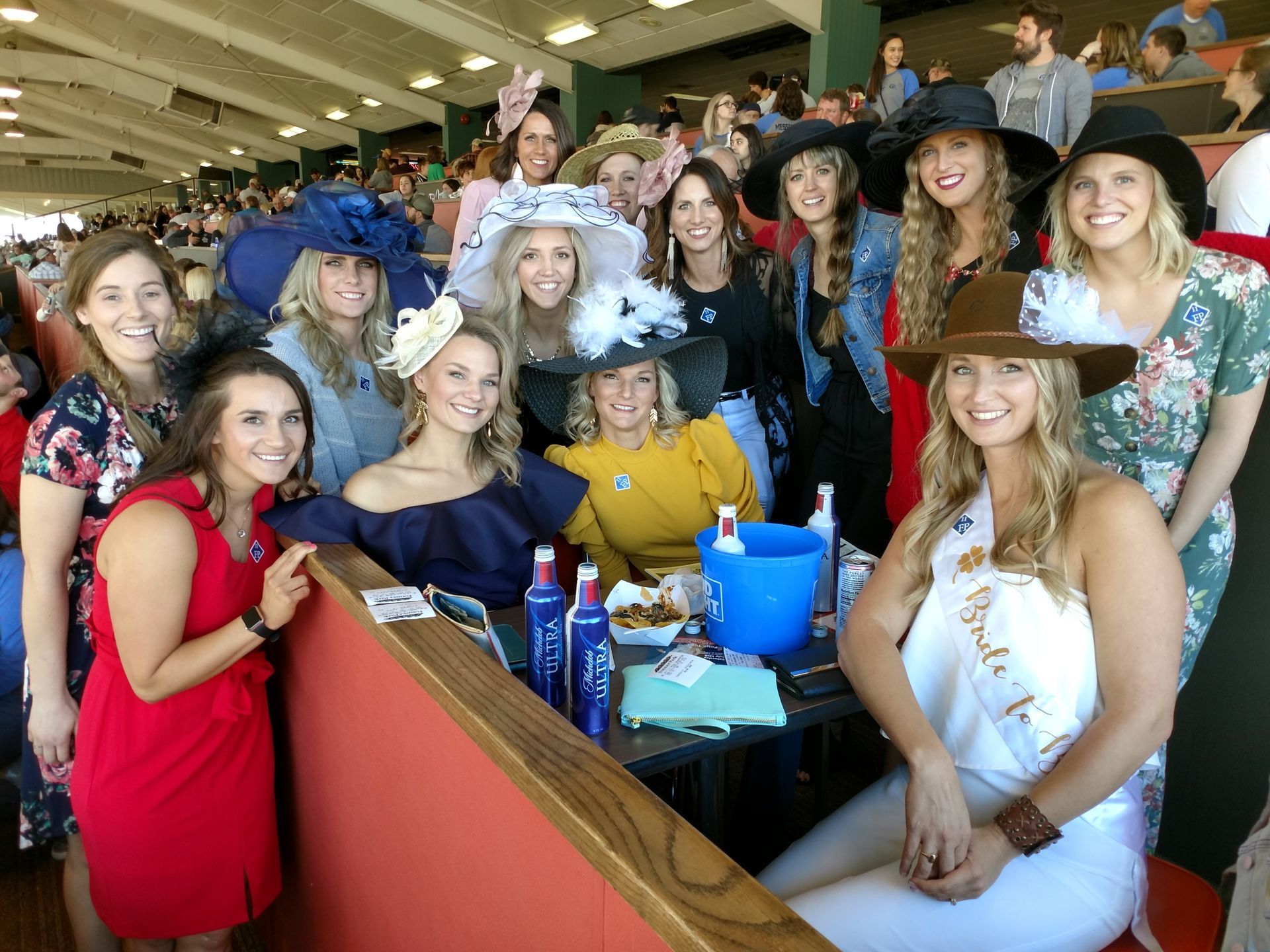 A group of women are posing for a picture in a stadium.