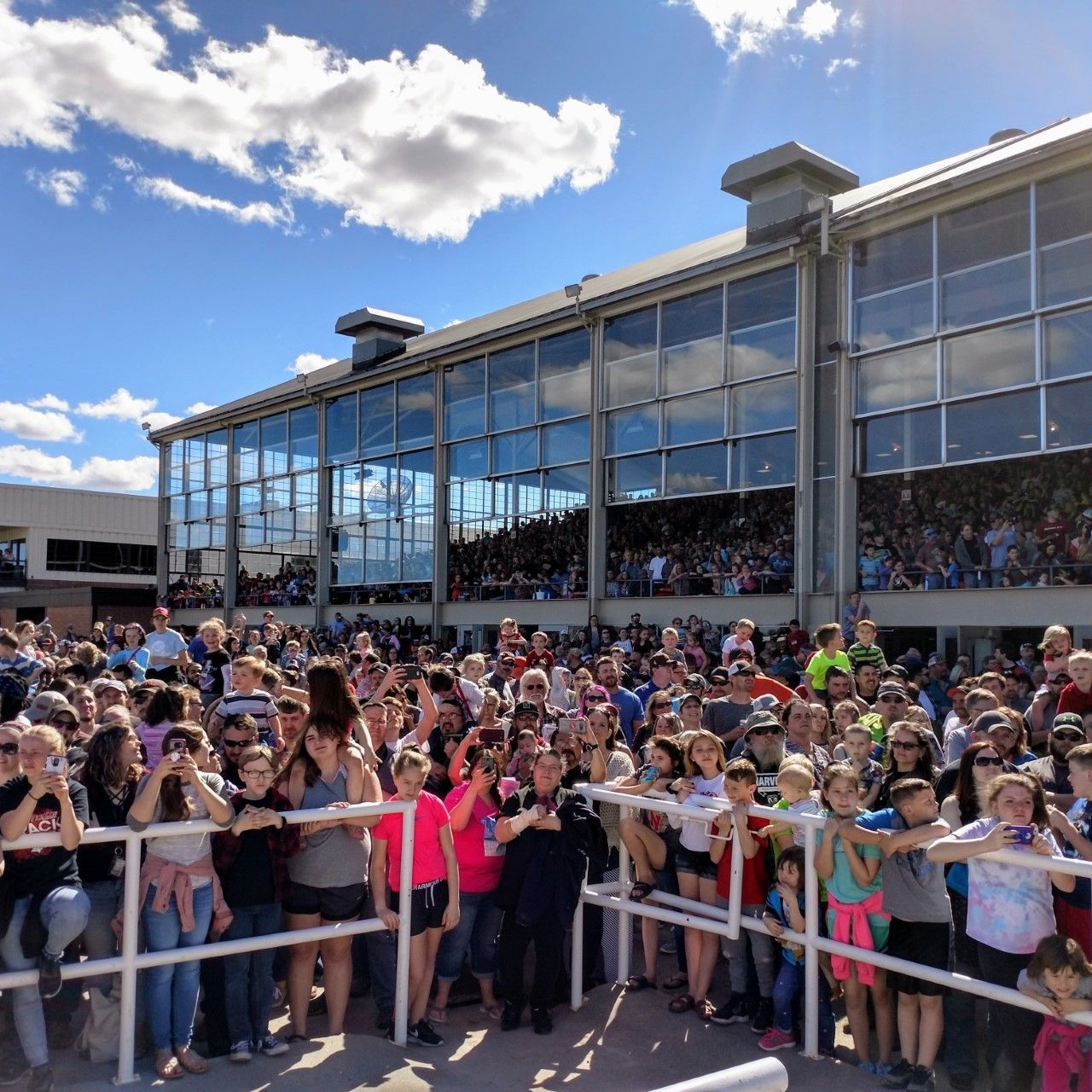 A large group of people are standing in front of a building