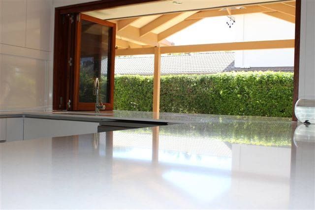 Kitchen With a Large Window and a White Counter Top — Advance Kitchens in Landsborough, QLD