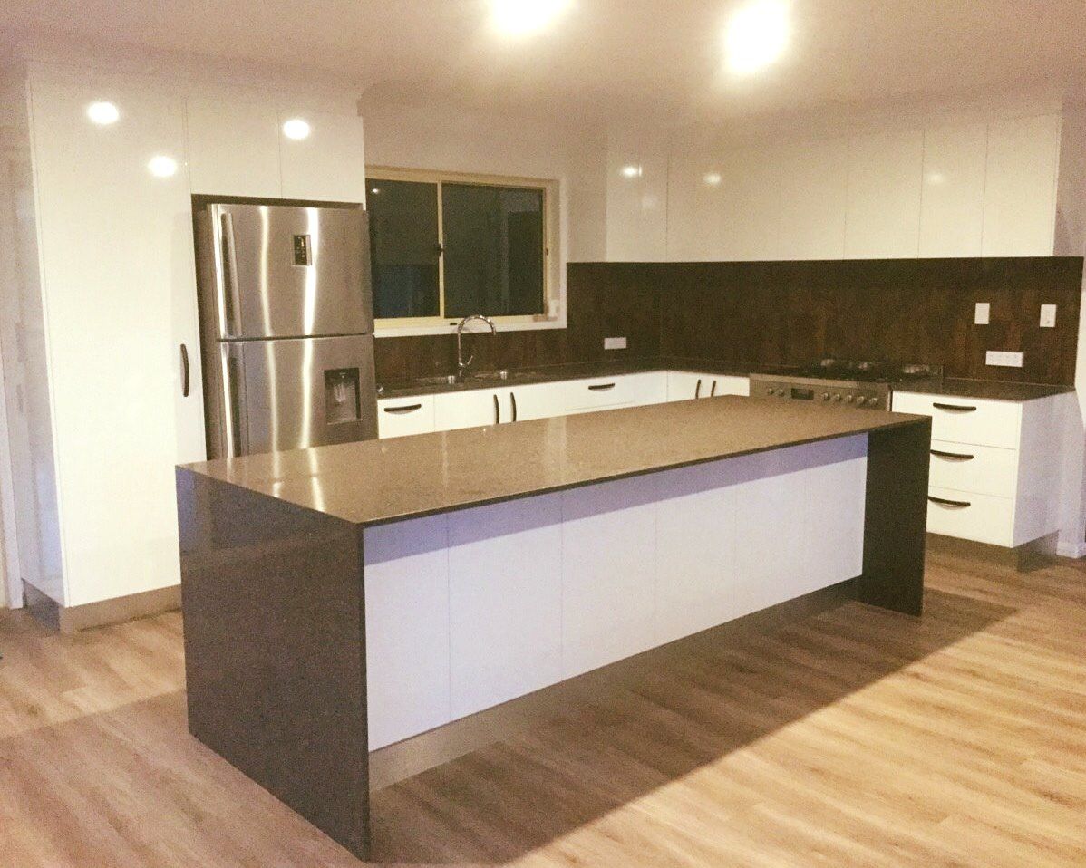 Kitchen With a Large Island and a Stainless Steel Refrigerator — Advance Kitchens in Beerwah, QLD