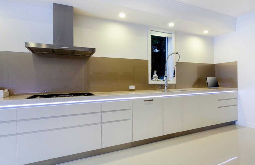 Kitchen With White Cabinets and a Stove Top Oven — Advance Kitchens in Caloundra West, QLD