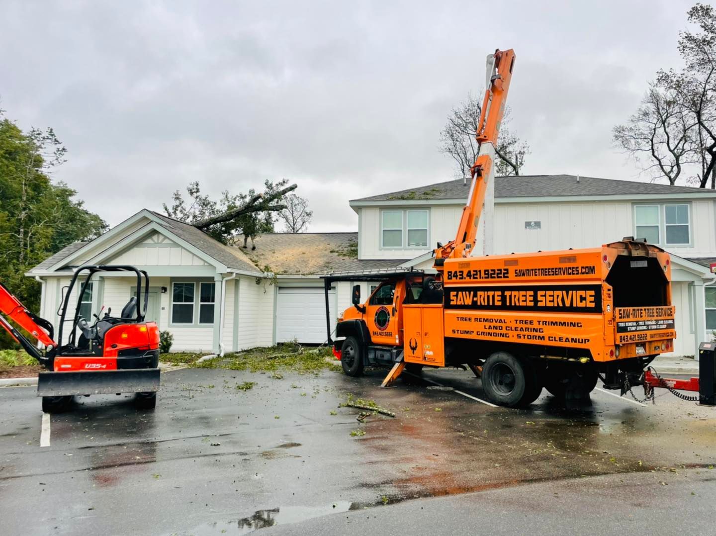 A tree service truck is parked in front of a house.