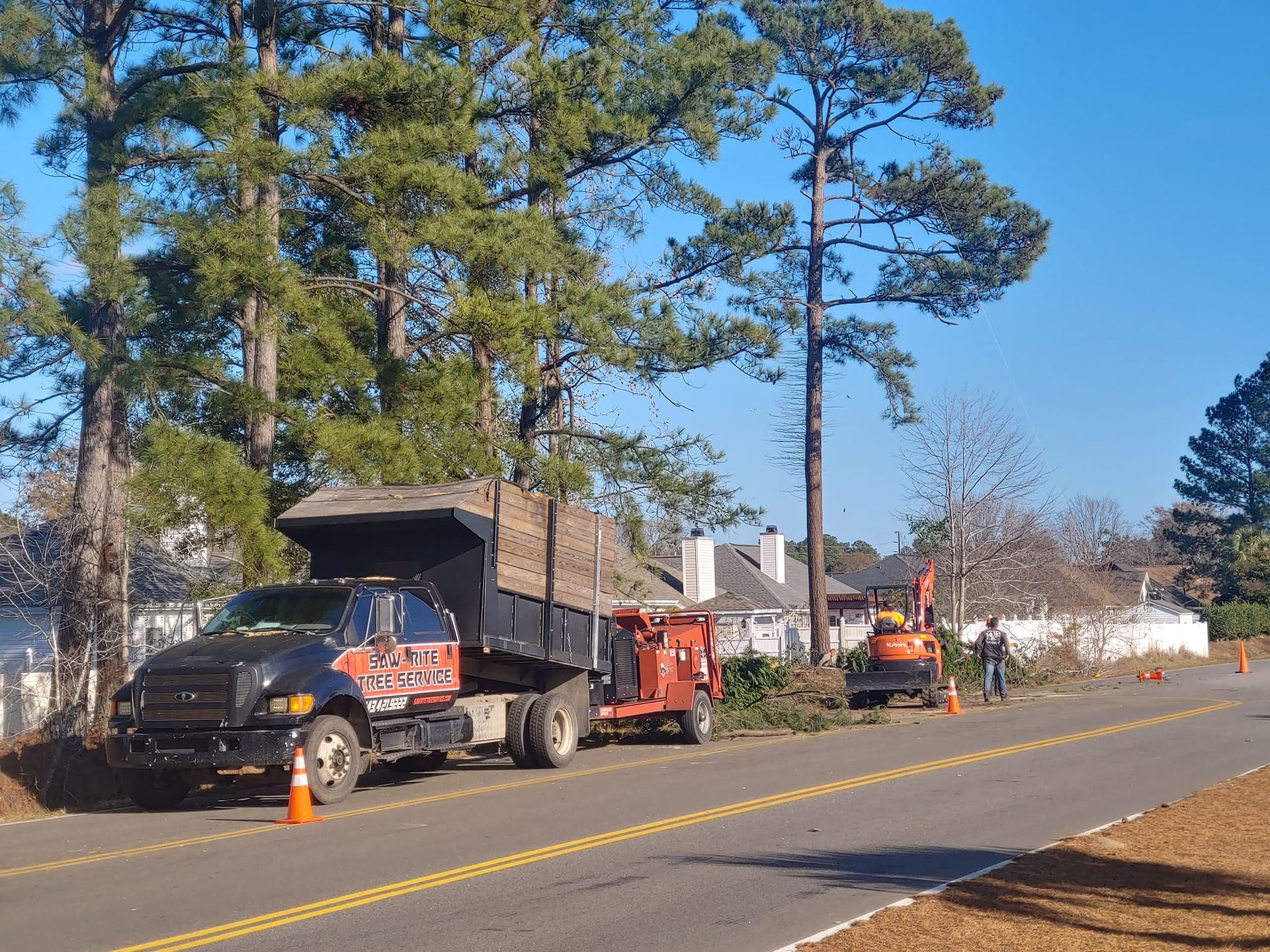 A dump truck is parked on the side of the road.
