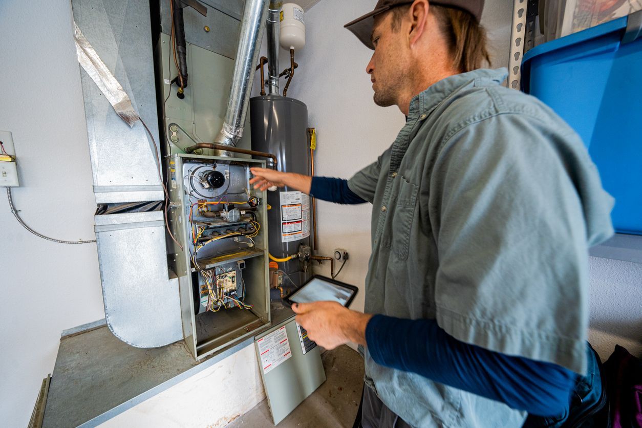 Technician inspecting an open electrical panel in a utility room