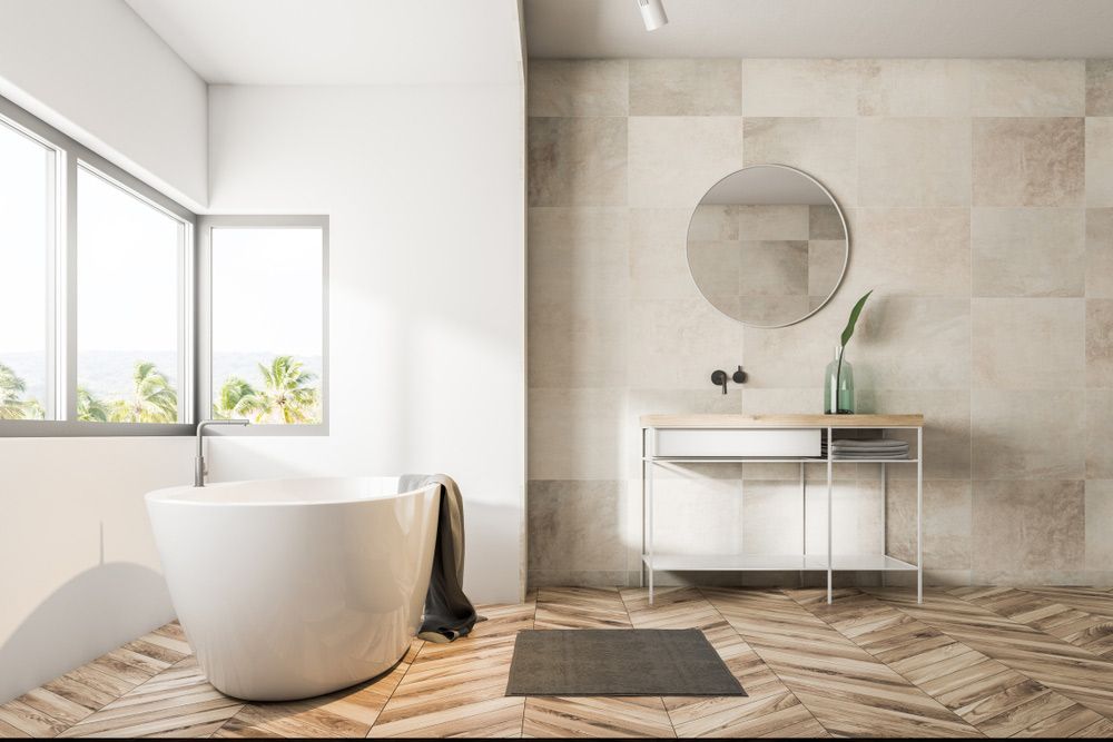 A Bathroom With a Tub, Sink, Mirror and Window — Maestro Tiling Services In Belconnen, ACT
