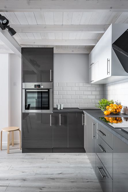 A Kitchen With Gray Cabinets, White Cabinets, a Stove, and a Stainless Steel Oven — Maestro Tiling Services In Belconnen, ACT