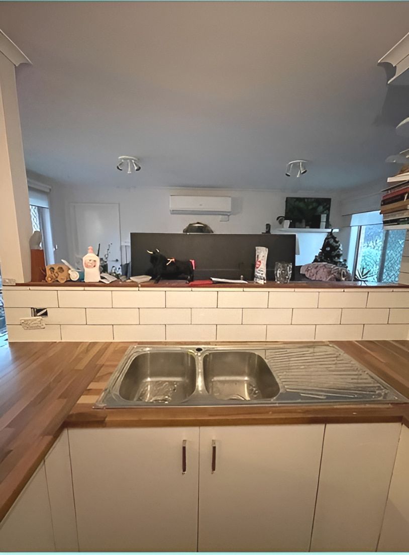 A Kitchen With a Sink and a Wooden Counter Top — Maestro Tiling Services In Latham, ACT