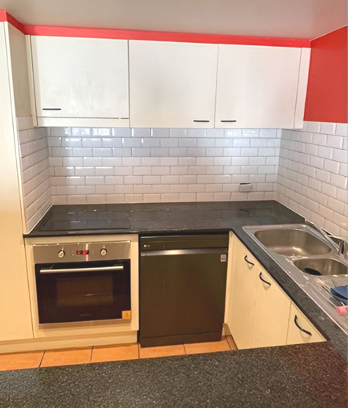A Kitchen With White Cabinets and a Black Dishwasher — Maestro Tiling Services In Latham, ACT