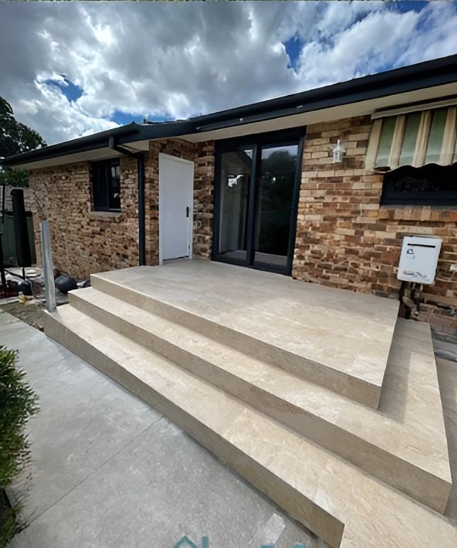 A Brick House With Stairs Leading Up to the Front Door — Maestro Tiling Services In Latham, ACT