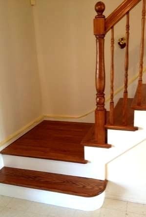 Wooden staircase with white risers and polished banister in a home interior