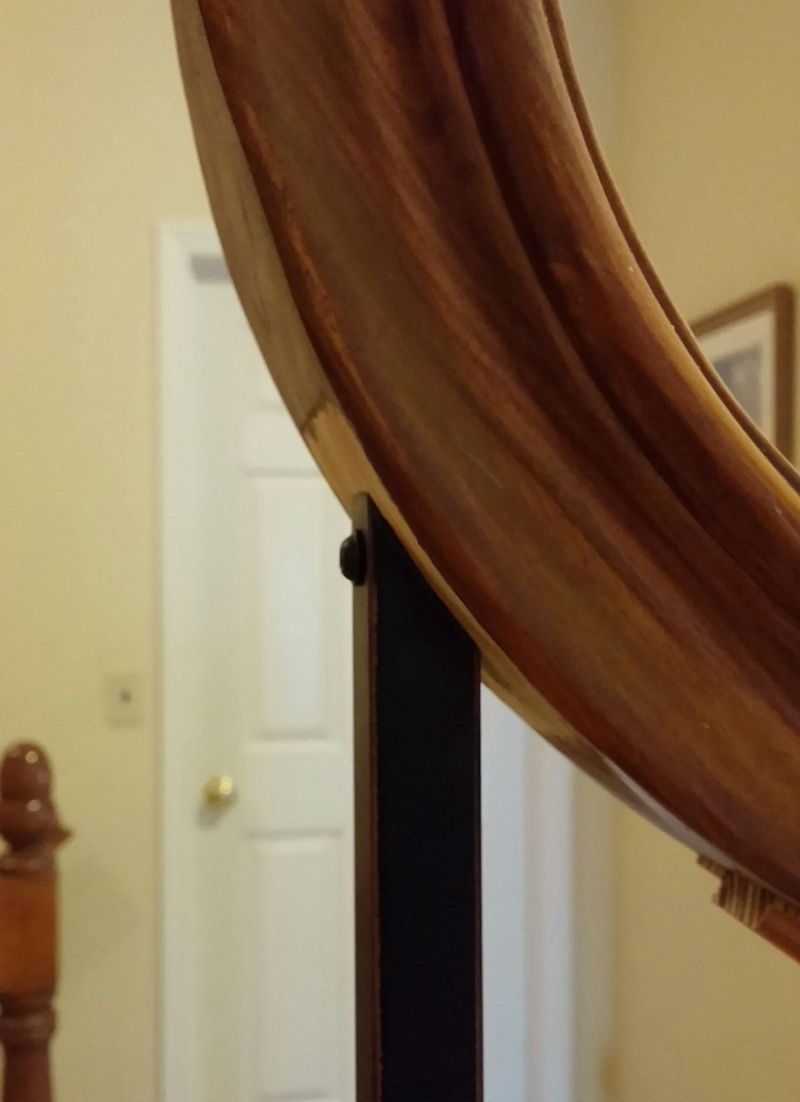 Brown draped fabric hanging in front of a bedroom doorway with a white door in the background