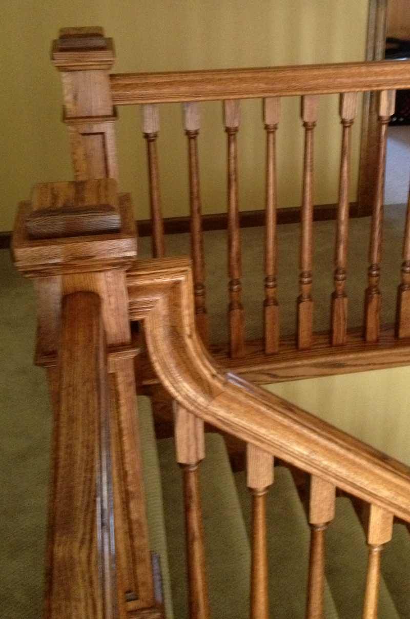 Wooden staircase banister and railing detail in a home interior