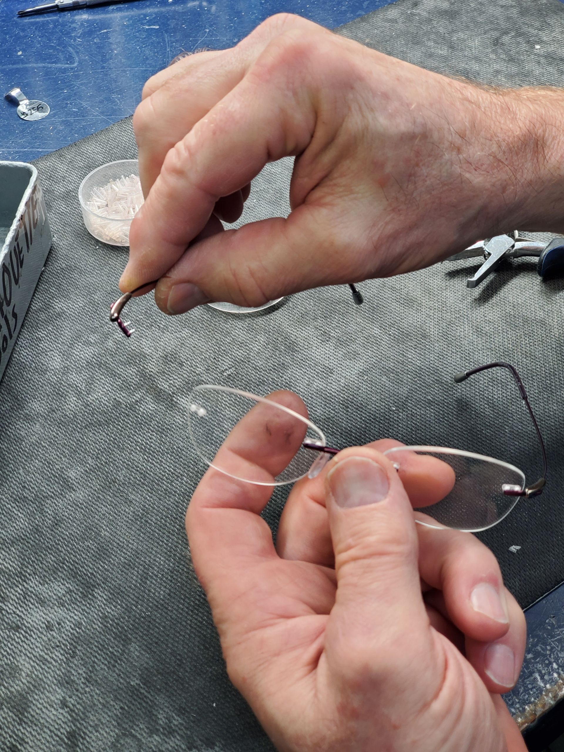 Person Fixing Eyeglass