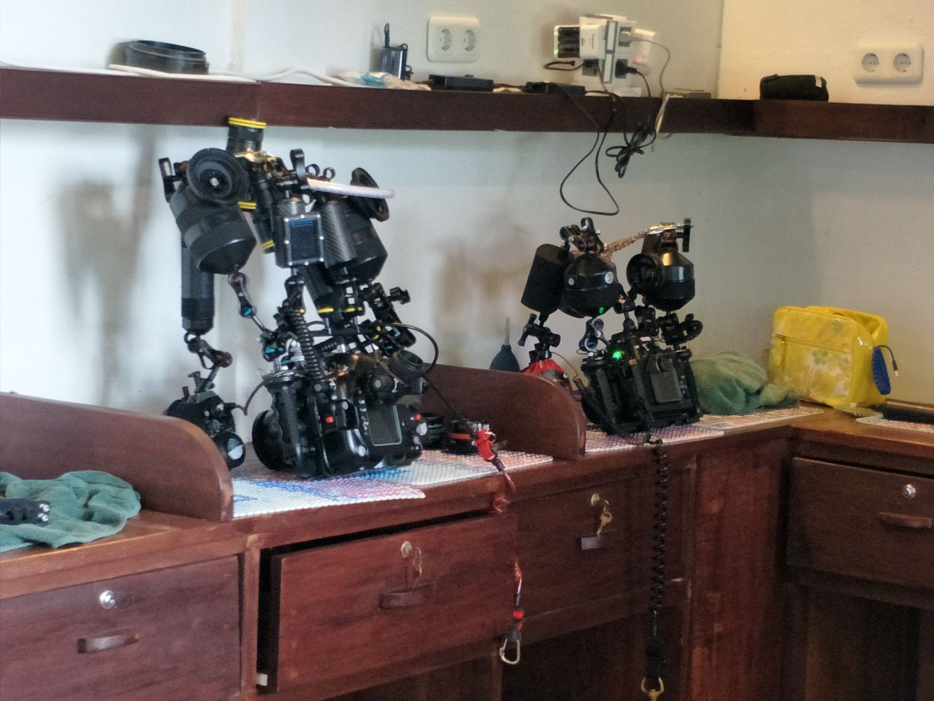 Lembeh Camera room - A bunch of cameras are sitting on a wooden table