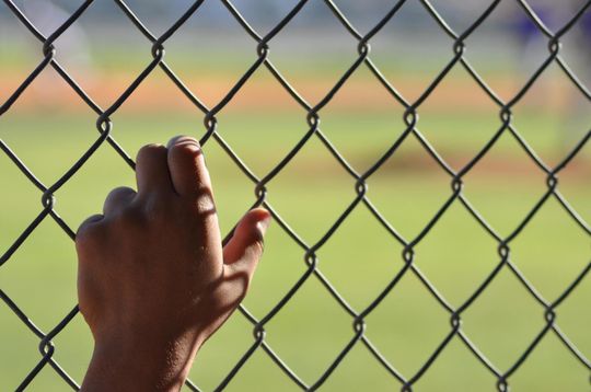 someone touching the chain link fence