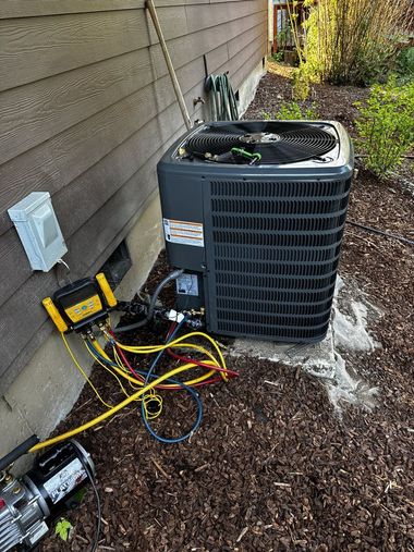 Outdoor AC condenser beside house with exposed hoses and tools, showing maintenance or repair work