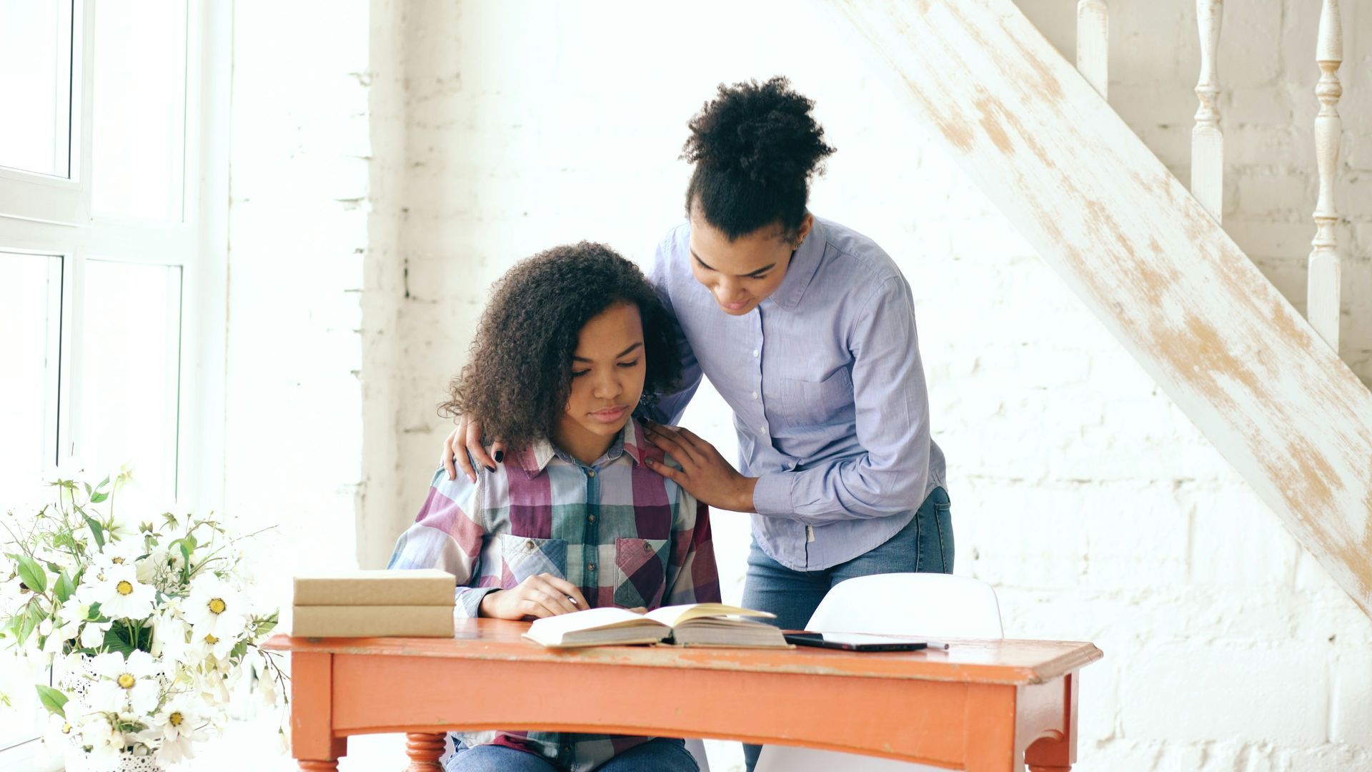 Parent supporting child while studying